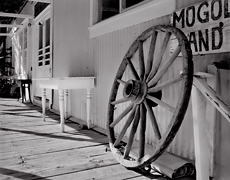 Wagon Wheel, Front Porch,  Mogollon, New Mexic.  Limited edition black and white photograph