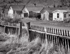 Fence and buildings, Bannack, MT. Black and white ghost town photograph